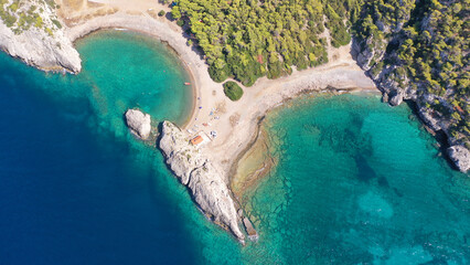 Aerial drone top down photo of scenic half moon shaped crystal clear sea beach of Milokopi near...