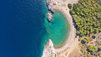 Aerial drone top down photo of beautiful half moon beach in tropical exotic island bay with deep turquoise sea