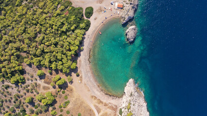 Fototapeta na wymiar Aerial drone top down photo of scenic half moon shaped crystal clear sea beach of Milokopi near famous lake Vouiagmeni, Loutraki, Perachora, Greece