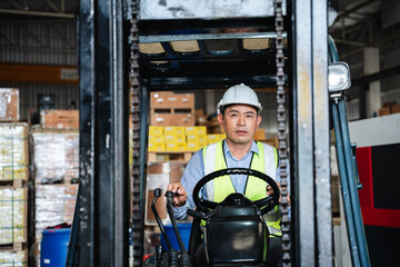 Fototapeta na wymiar Warehouse worker working with a forklift in a warehouse or storehouse.