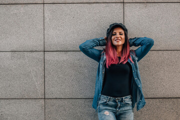 urban hipster woman on street wall