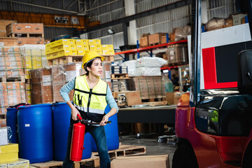 Group of warehouse worker holding a fire extinguisher for prepares for dangerous situations in...