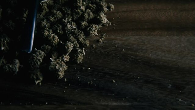 Wooden pipe for smoking marijuana on the table against the background of a buds of cbd sativa or indica tgk. Drugs and medicine.