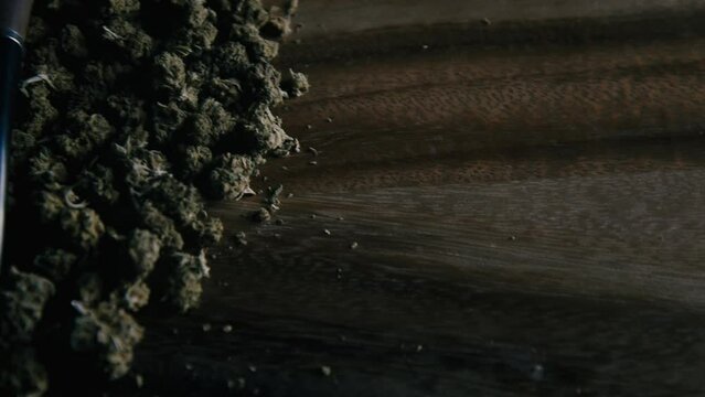 Wooden pipe for smoking marijuana on the table against the background of a buds of cbd sativa or indica tgk. Drugs and medicine.
