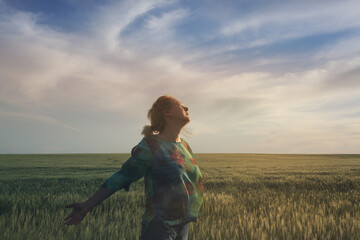 Happy woman raise hands on wheat field and sky soft landscape. Light delicate pastel color tone....