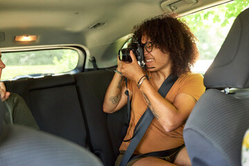 LGBTQ couple taking photos of each other while on a road trip