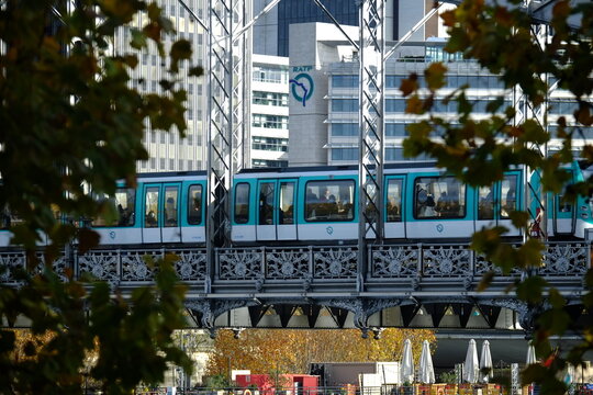 Paris, France - November the 28th 2022: The RATP head quarters and a metro crossing the Seine river on the Austerlitz bridge.