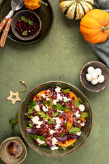 Warm winter quinoa salad with pumpkin, chorizo and mozzarella, arugula leaves and pomegranate.