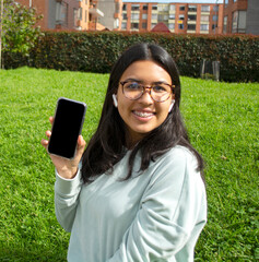 Woman taking a selfie photo with phone smiling.