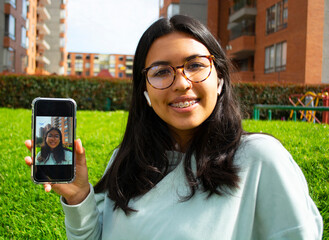 Woman taking a selfie photo with phone smiling