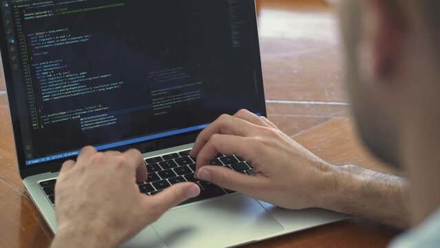 Male coding on laptop. Web developing and software code concept