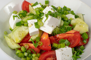 Greek Salad in White Bowl, Macro Photo of Fresh Garden Salat, Salad with Green Onion, Feta, Tomatoes Closeup