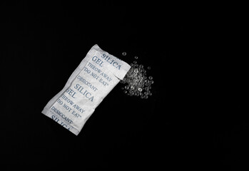 Naklejka premium Desiccant Silica Gel Adsorbent Crystals on Black Background, Desiccant Polymer Balls