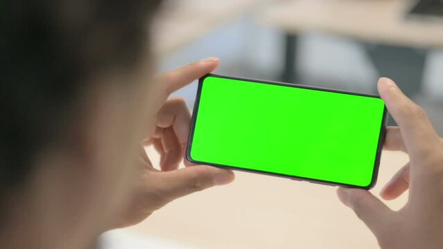 Close Up of African Man Holding Green Screen Smartphone