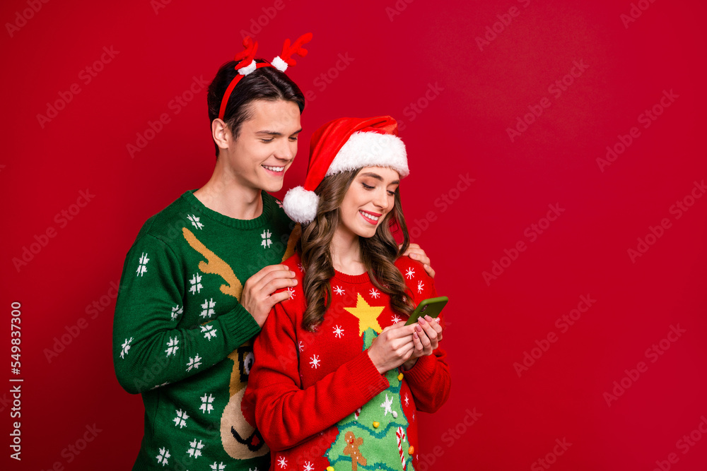 Sticker portrait of two people embrace use telephone eshop media app santa headwear reindeer antlers isolate