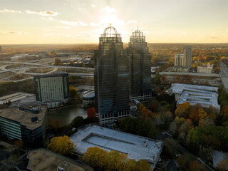 Aerial view of commercial buildings in Atlanta Metro Area with sun rays during sunset - obrazy, fototapety, plakaty