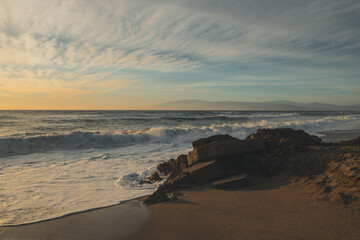 Sunset on a beach with waves