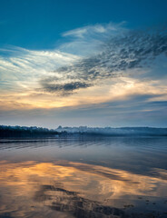 Lake with fog and embankment with evening sky. Ternopil, Ukraine