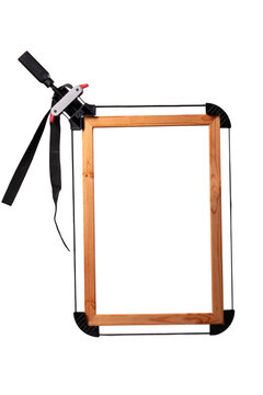 Gluing a wooden picture frame with a special carpenter's clamp.