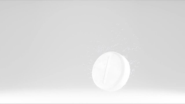 Effervescent tablet in water with bubbles. White medicine pill in with bubbles on white background.