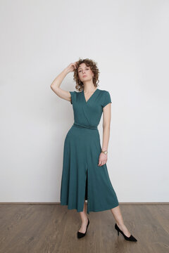 Serie of studio photos of young female model in green viscose wrap dress.