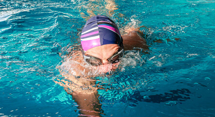 Swimmer in the pool. A male athlete is engaged in swimming in a sports pool.