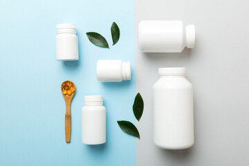 supplement pills with medicine bottle health care and medical top view. Vitamin tablets. Top view mockup bottle for pills and vitamins with green leaves, natural organic bio supplement, copy space