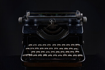 old vintage typewriter isolated on black background