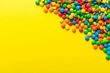 Mixed collection of colorful candy, on colored background. Flat lay, top view. frame of colorful chocolate coated candy