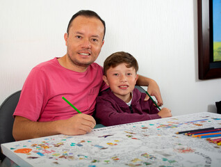 Dad teaches his son how to paint.