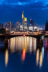Frankfurt skyline with its reflections in the river Main during blue hour