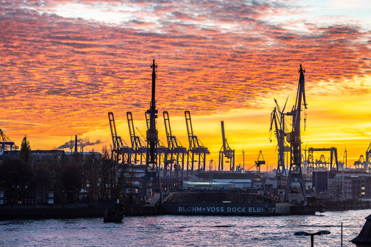 HAMBURG, GERMANY, 12th November 2022: Cranes of the port of Hamburg during sunset