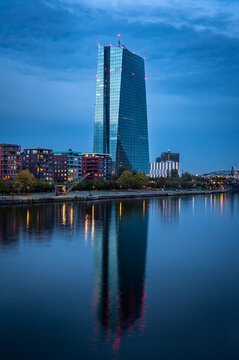 European central bank with reflections in river Main during blue hour