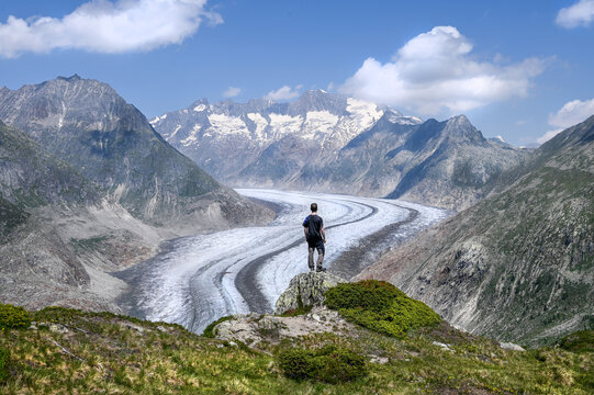 A man is looking down on Altsch glacier in the alps