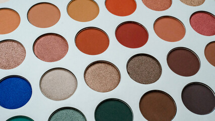 Selective focus of eyeshadow palette with various colors in pearly and matte closeup