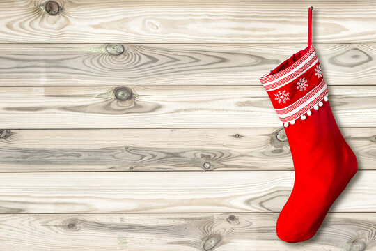 Red Christmas stocking red sock on wooden background