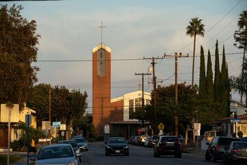 Sunset illuminates a church in a downtown neighborhood of Artesia, California, USA.