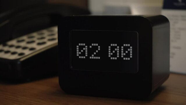 The clock or alarm clock shows the time 02 o'clock. Time display on the electronic scoreboard. Wake up or getting up for work, study or in connection with an important