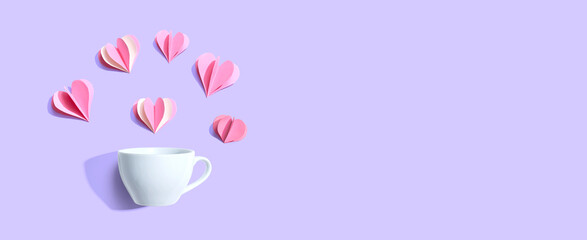 Coffee cup with paper craft hearts - flat lay