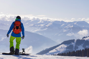 man and woman skiing and snowboarding in the mountains, ski resort