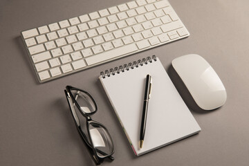 Keyboard, glasses and notepad