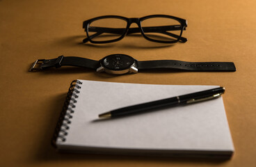 Glasses, notebook and hour