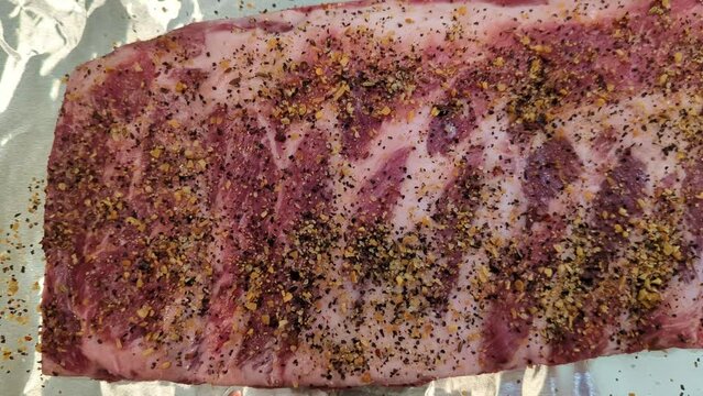 Panning over well seasoned pork ribs on tin foil 