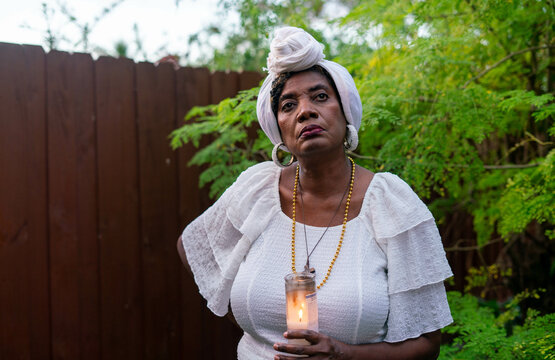 Caribbean woman dressed in all white in nature