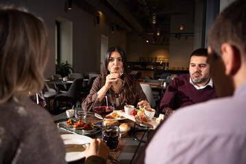 Group of Happy friends having lunch in the restaurant