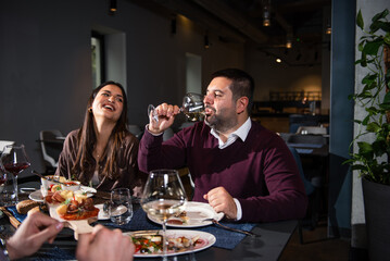 People Laughing at Dinner Table