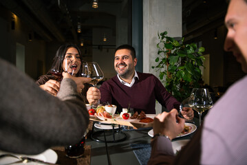 Group of Happy friends having lunch in the restaurant