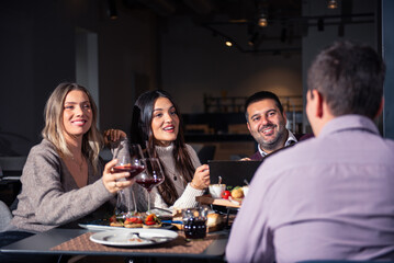 Group of Happy friends having lunch in the restaurant