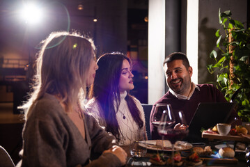 Group of Happy friends having dinner in the restaurant