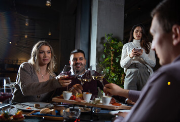 Group of Happy friends having dinner in the restaurant